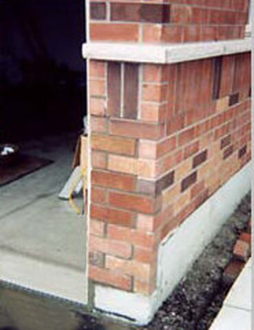 The same corner rebuilt with colour-matched brick