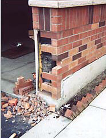 Collapsed brick porch corner before rebuild