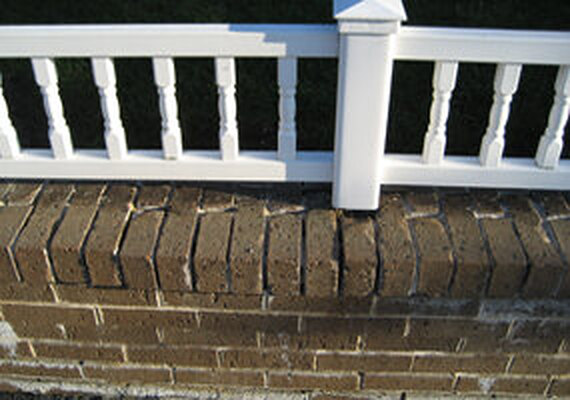 Worn garden wall before restoration