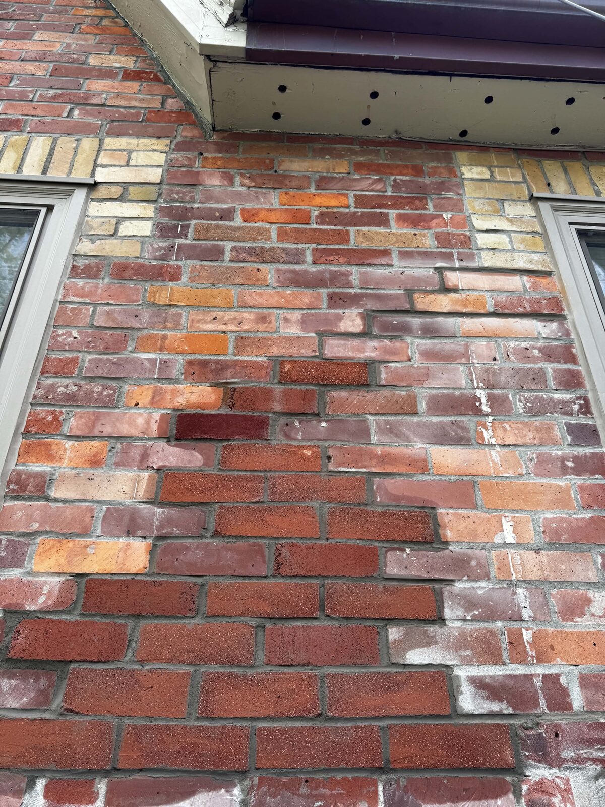 Brick wall repair with colour-matched replacement brick