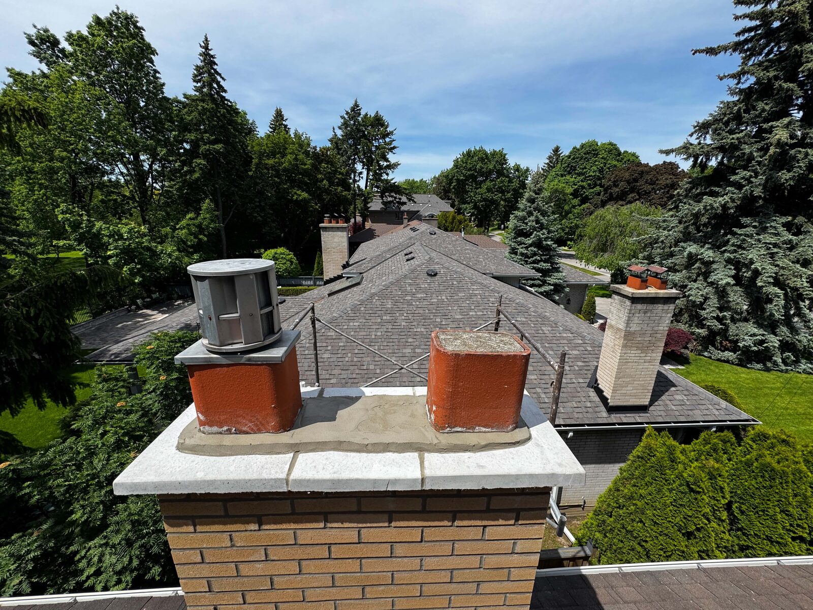 Rebuilt chimneys over a west Toronto rooftop, Krolicki Masonry