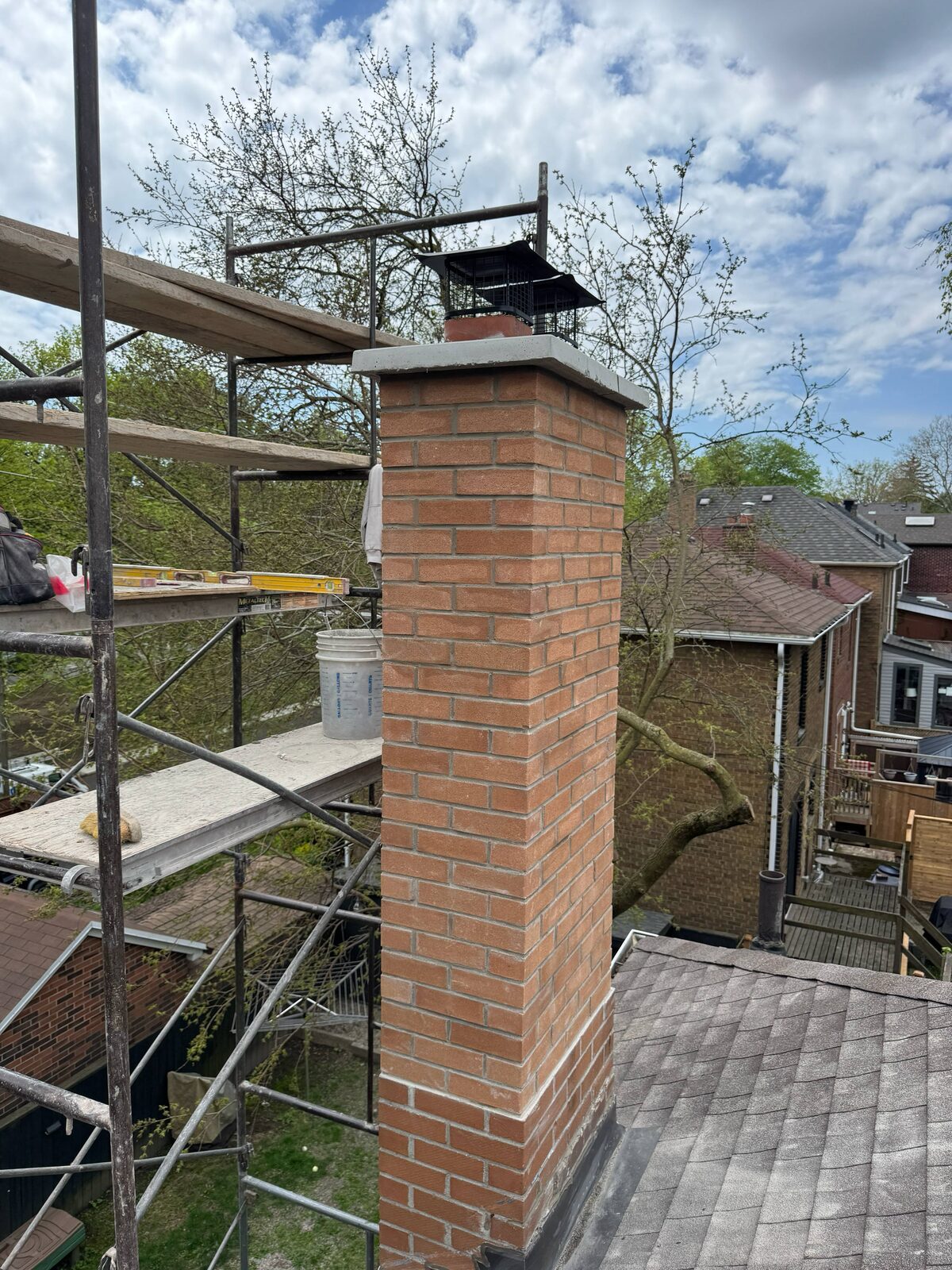 Chimney rebuild in progress on scaffolding, Toronto
