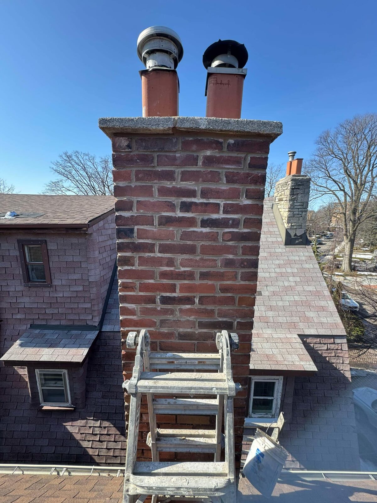 Double-flue chimney rebuild on scaffolding, west Toronto street