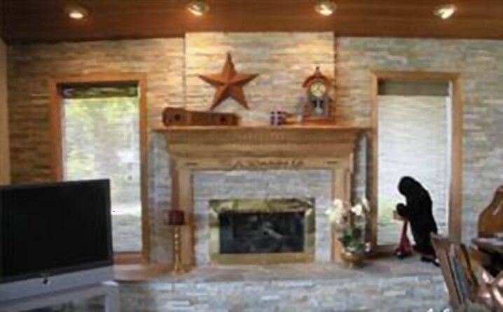 Restored floor-to-ceiling stone fireplace by Krolicki Masonry