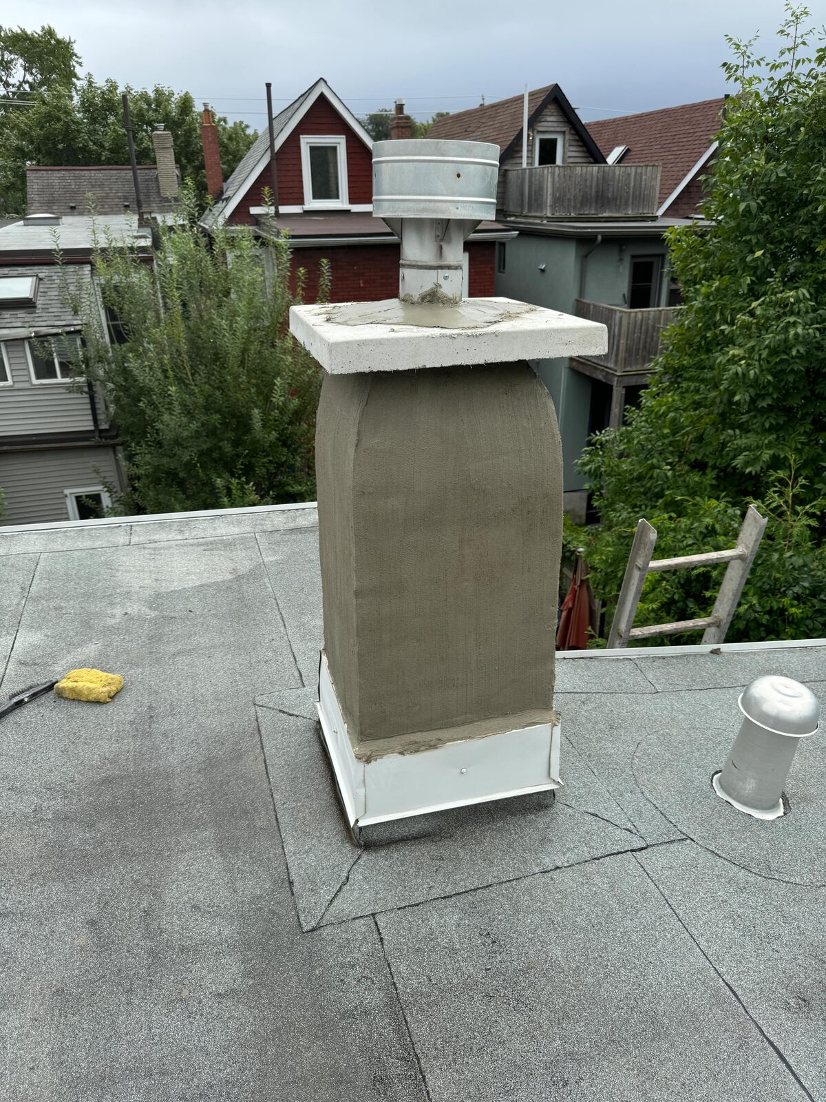 Freshly parged chimney on a flat roof